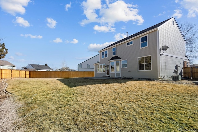 back of property with cooling unit and a yard