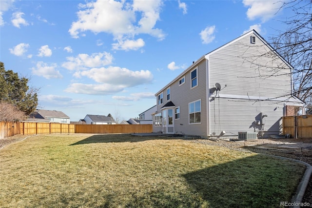 back of house featuring cooling unit and a yard