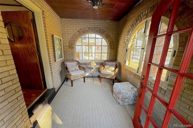 sunroom / solarium with wooden ceiling and a ceiling fan