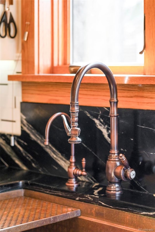 details with dark countertops and a sink