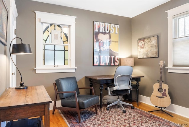 office space featuring baseboards and wood finished floors