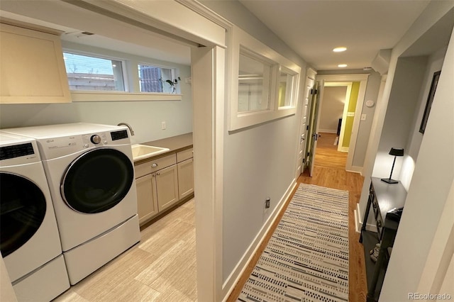 laundry area featuring a sink, recessed lighting, cabinet space, baseboards, and washing machine and clothes dryer