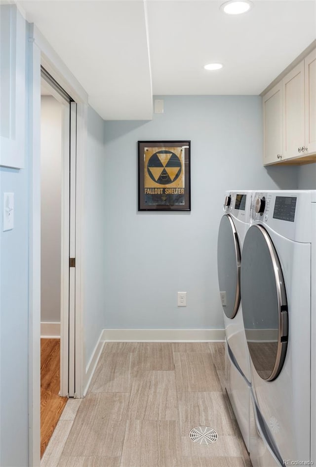 laundry room featuring light wood-type flooring, cabinet space, independent washer and dryer, and baseboards