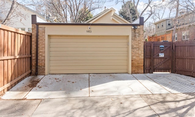 garage featuring a gate and fence