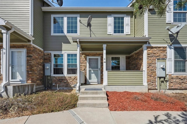 12728 Jasmine St Unit E, Thornton, CO 80602 - view of front of home with a porch and stone siding