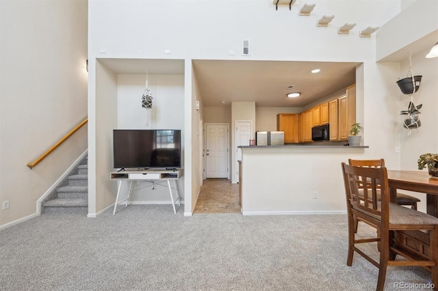 12728 Jasmine St Unit E, Thornton, CO 80602 - interior space with dark countertops, black microwave, light carpet, baseboards, and visible vents