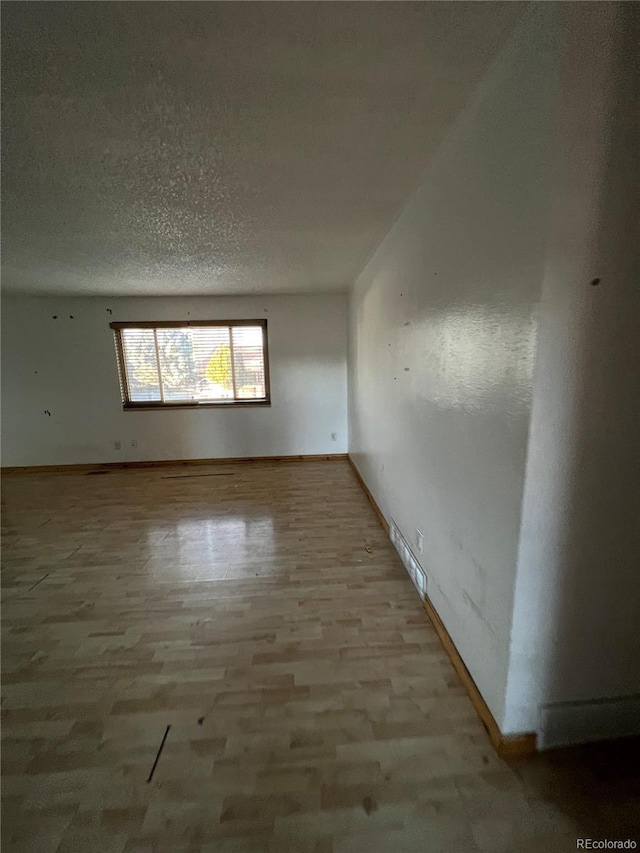 empty room with a textured ceiling