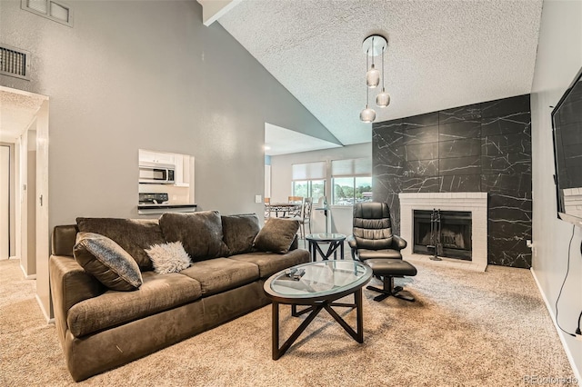 8100 W Quincy Ave Unit 11, Denver, CO 80123 - living room with carpet, a tile fireplace, a textured ceiling, and high vaulted ceiling