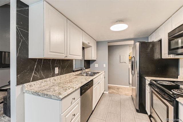 8100 W Quincy Ave Unit 11, Denver, CO 80123 - kitchen featuring stainless steel appliances, a sink, light countertops, white cabinetry, and tasteful backsplash