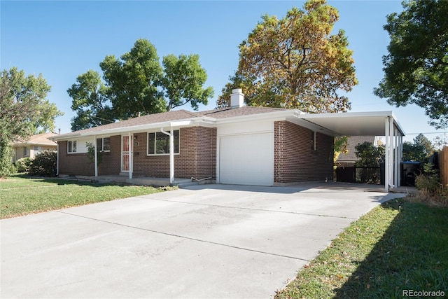 view of front of home with a carport, a garage, and a front yard