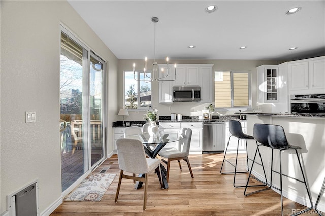 dining space featuring a chandelier and light hardwood / wood-style floors