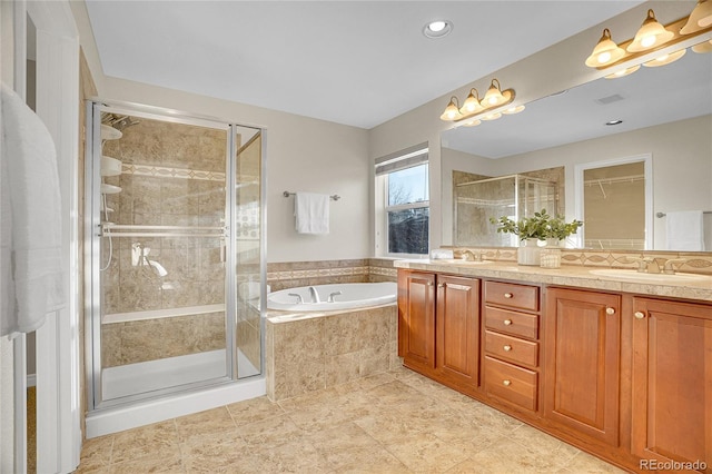 bathroom with vanity and separate shower and tub