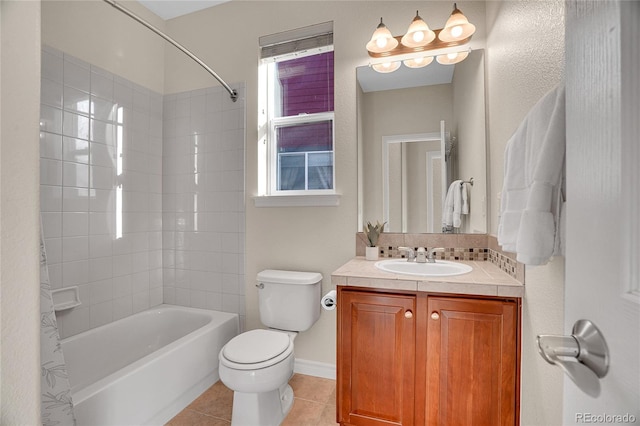 full bathroom with tiled shower / bath, tile patterned floors, toilet, and vanity