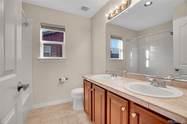 full bathroom featuring vanity, tiled shower / bath, tile patterned flooring, and toilet