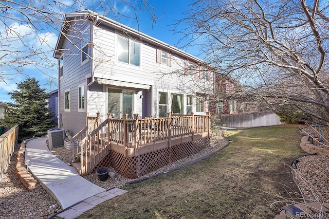 rear view of house featuring a wooden deck, a lawn, and central air condition unit