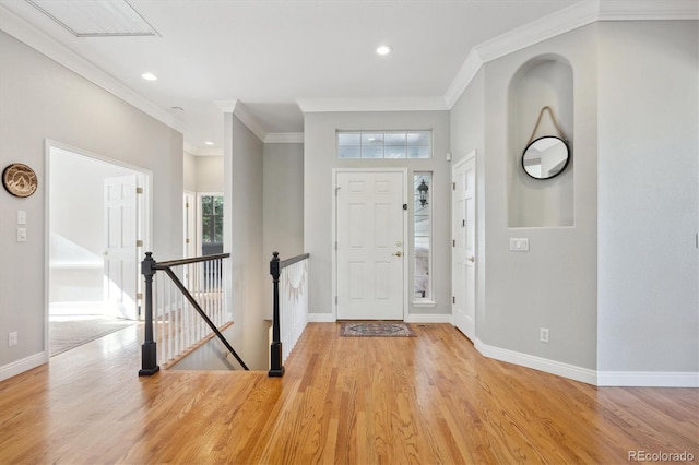 entrance foyer with light hardwood / wood-style floors and ornamental molding