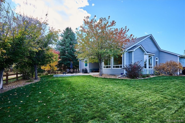 rear view of house with a yard