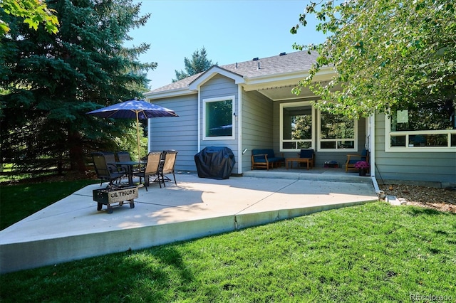 rear view of house with a patio area and a lawn