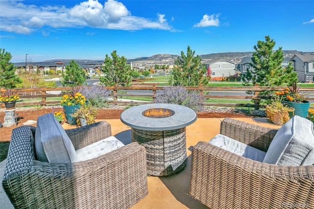 view of patio / terrace featuring a mountain view and an outdoor fire pit