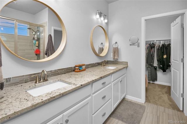 bathroom with tasteful backsplash, vanity, and an enclosed shower