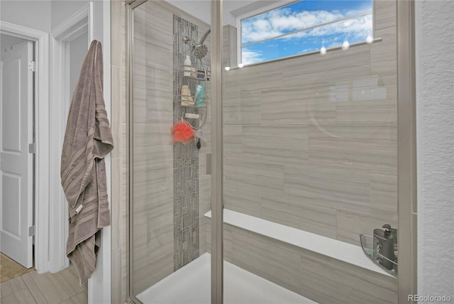 bathroom with a shower with door