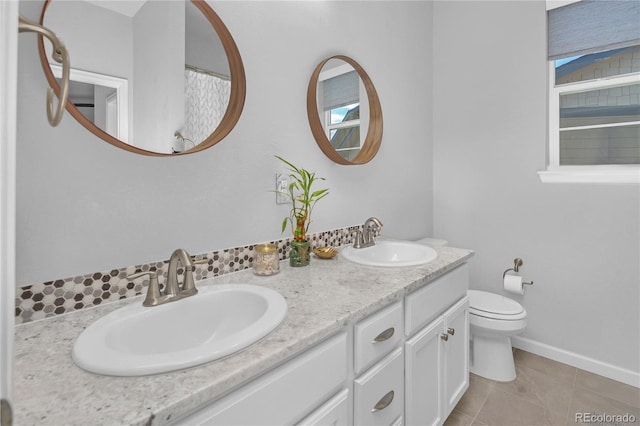 bathroom with vanity, toilet, and tile patterned flooring