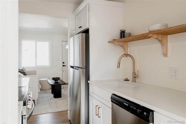 kitchen featuring white cabinets, dark hardwood / wood-style floors, sink, and appliances with stainless steel finishes