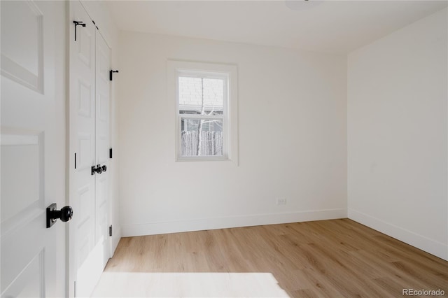 spare room with light hardwood / wood-style flooring