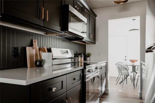 kitchen featuring appliances with stainless steel finishes and light hardwood / wood-style floors