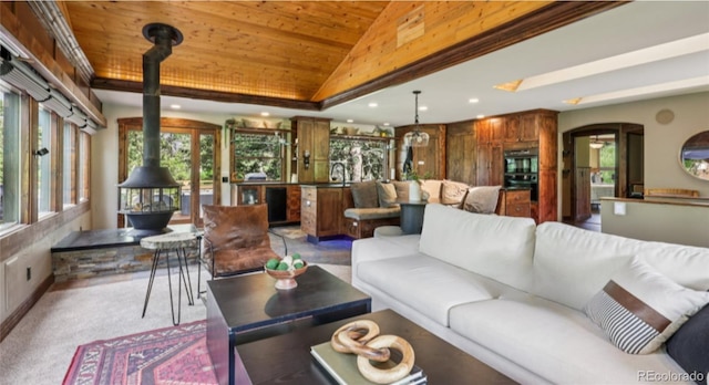 20033 Silver Ranch Rd, Conifer, CO 80433 - living room with a wood stove, lofted ceiling, wooden ceiling, arched walkways, and recessed lighting