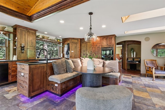 20033 Silver Ranch Rd, Conifer, CO 80433 - kitchen with recessed lighting, dark countertops, arched walkways, dark stone finish floors, and healthy amount of natural light