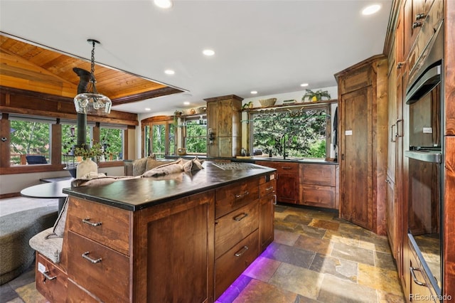 20033 Silver Ranch Rd, Conifer, CO 80433 - kitchen featuring wood ceiling, dark countertops, black oven, recessed lighting, and a center island