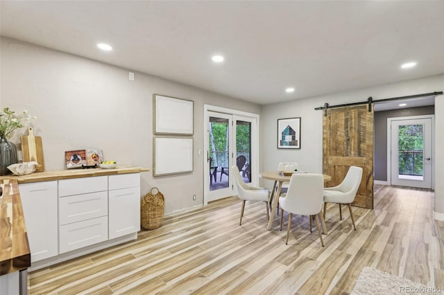 20033 Silver Ranch Rd, Conifer, CO 80433 - dining area with a barn door, light wood-style flooring, and recessed lighting