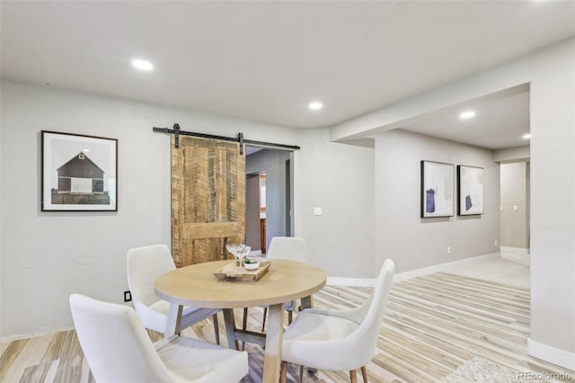 20033 Silver Ranch Rd, Conifer, CO 80433 - dining room with a barn door, light wood-type flooring, and recessed lighting