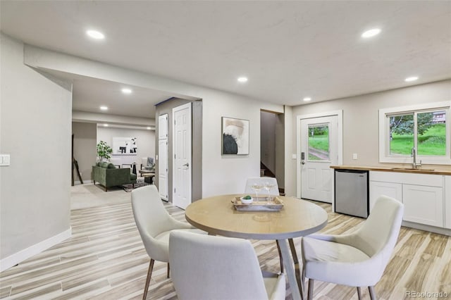 20033 Silver Ranch Rd, Conifer, CO 80433 - dining room featuring light wood-type flooring, recessed lighting, and stairs