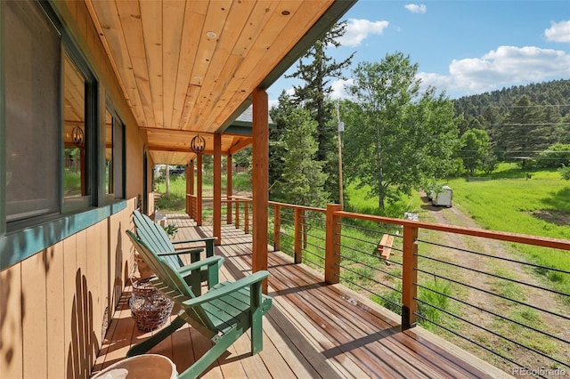 20033 Silver Ranch Rd, Conifer, CO 80433 - wooden deck with a forest view and a yard