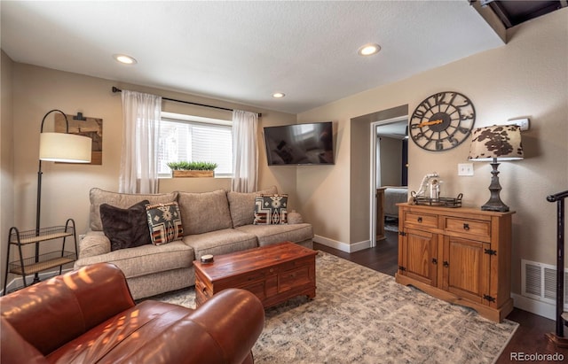 315 Maestes St, Johnstown, CO 80534 - living area with a textured ceiling, visible vents, baseboards, dark wood-style floors, and recessed lighting