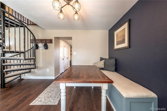 315 Maestes St, Johnstown, CO 80534 - unfurnished dining area featuring stairway, a textured ceiling, baseboards, and wood finished floors