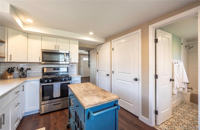 315 Maestes St, Johnstown, CO 80534 - kitchen with blue cabinetry, appliances with stainless steel finishes, wood counters, recessed lighting, and white cabinetry