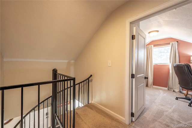 315 Maestes St, Johnstown, CO 80534 - interior space with a textured ceiling, carpet floors, baseboards, an upstairs landing, and lofted ceiling