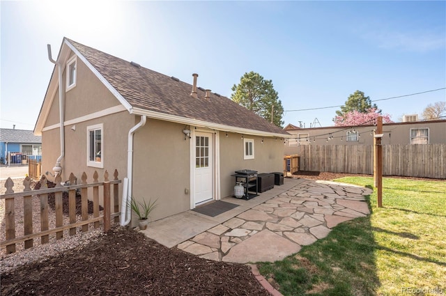 315 Maestes St, Johnstown, CO 80534 - rear view of property with a yard, a patio, fence private yard, and stucco siding