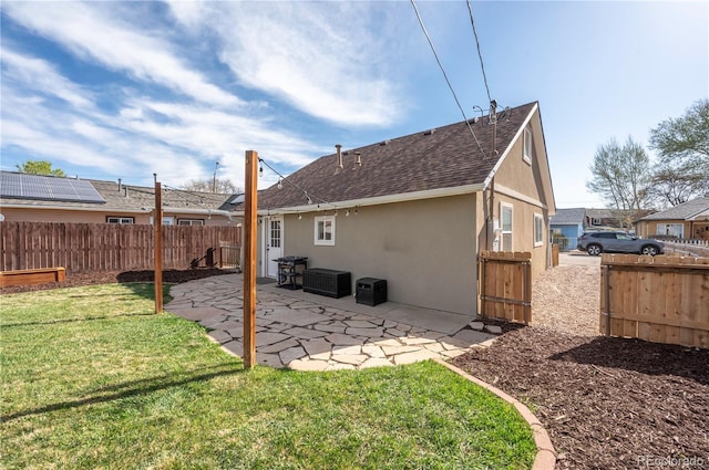 315 Maestes St, Johnstown, CO 80534 - rear view of house with a yard, fence, a patio area, and stucco siding