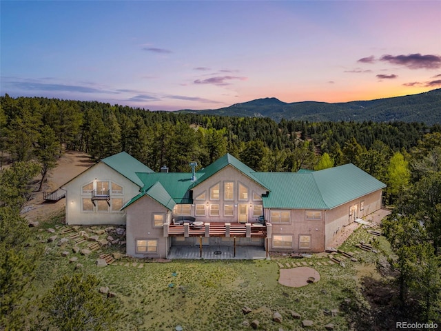 aerial view at dusk featuring a mountain view