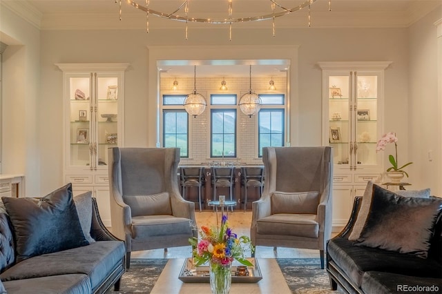 sitting room with an inviting chandelier and ornamental molding