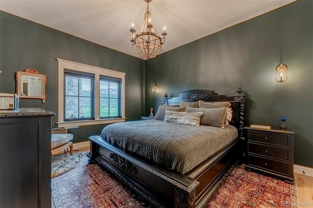 bedroom featuring a chandelier and hardwood / wood-style flooring