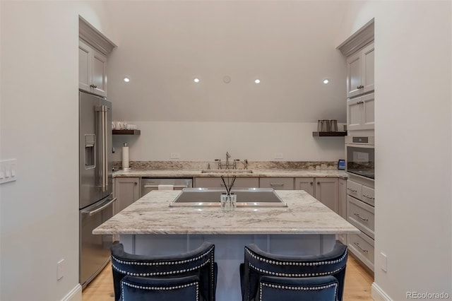 921 County Road 317, Crested Butte, CO 81224 - kitchen with stainless steel appliances, a breakfast bar, and gray cabinetry