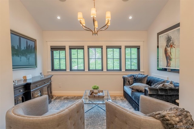 living room featuring plenty of natural light, lofted ceiling, and an inviting chandelier