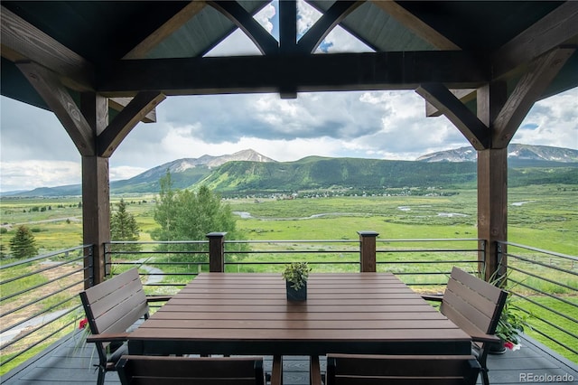921 County Road 317, Crested Butte, CO 81224 - wooden terrace with a view of countryside, a mountain view, and outdoor dining area