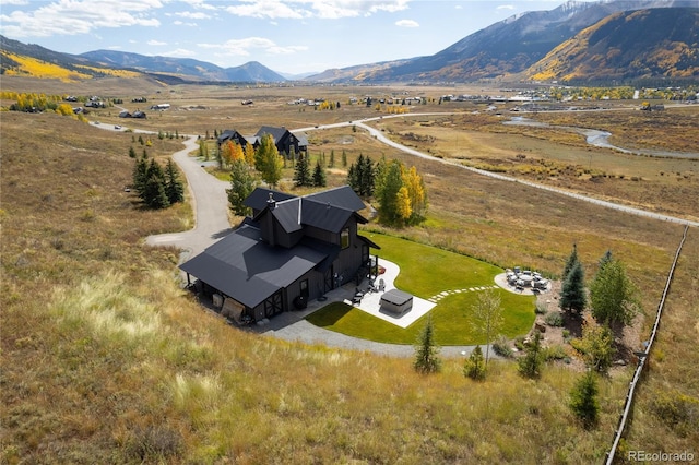 drone / aerial view with a mountain view and a rural view