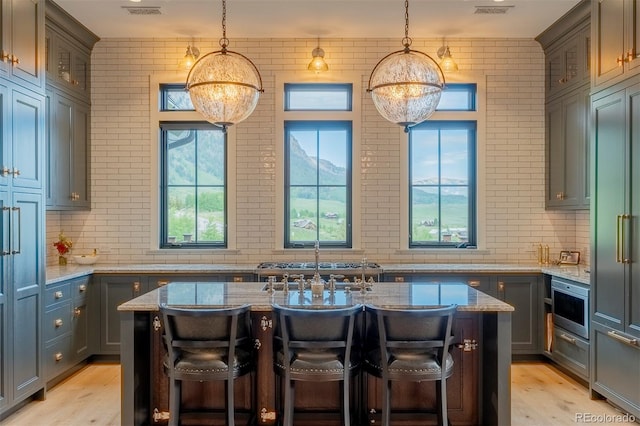 921 County Road 317, Crested Butte, CO 81224 - kitchen featuring healthy amount of natural light, light wood-style flooring, and light stone counters